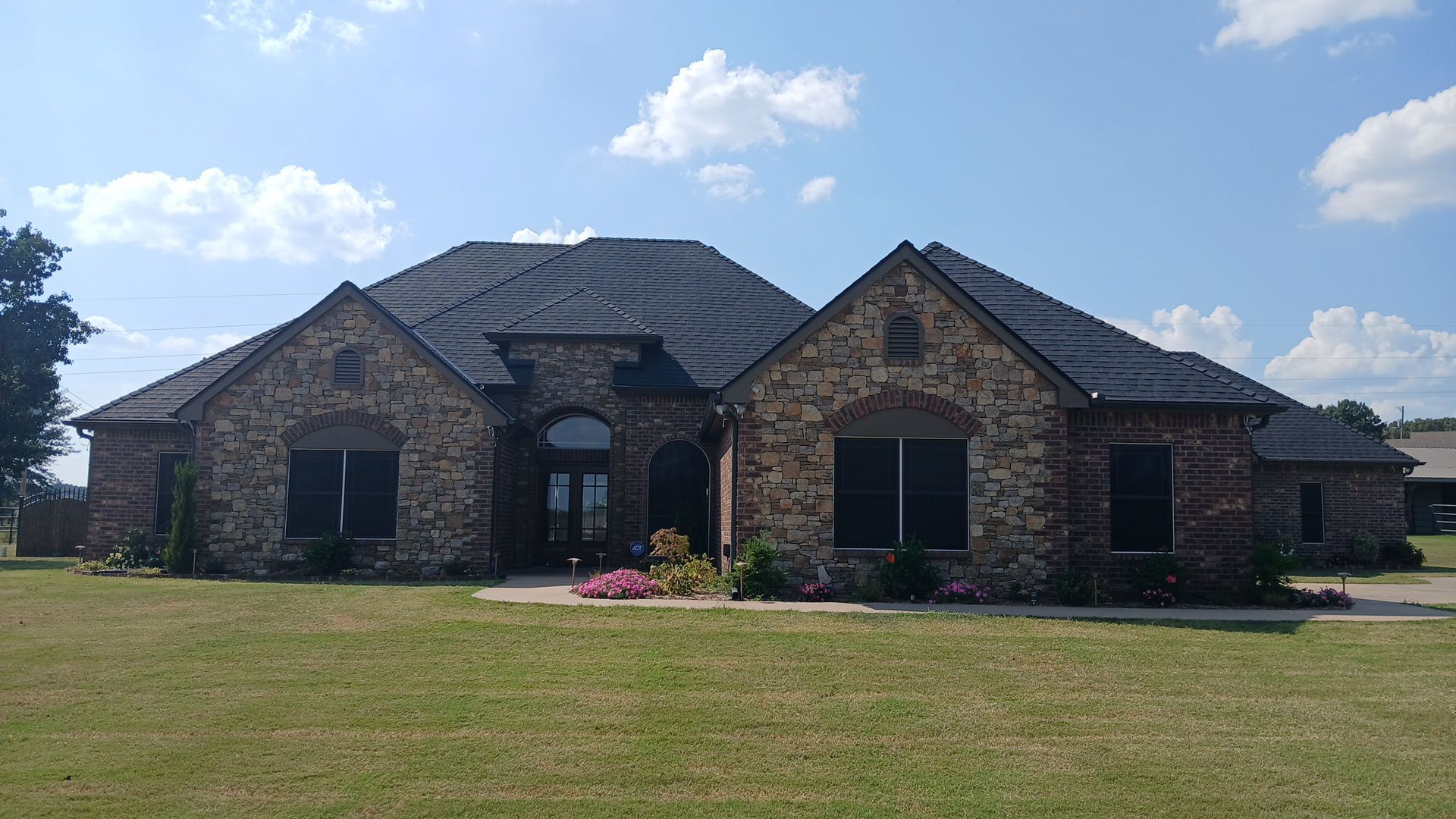 Happy family in front of their home with a new roof